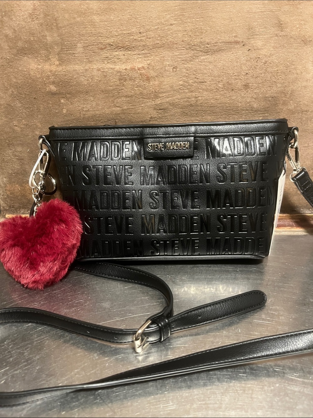 Steve Madden Black Embossed Logo Crossbody with Red Pom Charm